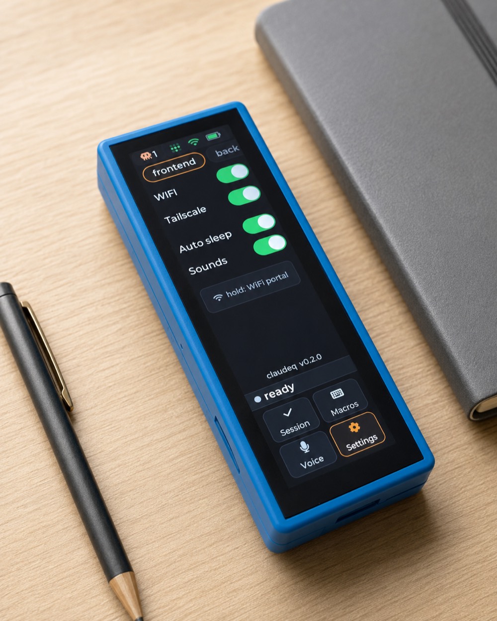The claudeq device on a wooden desk beside a pen and notebook, showing the Settings screen.